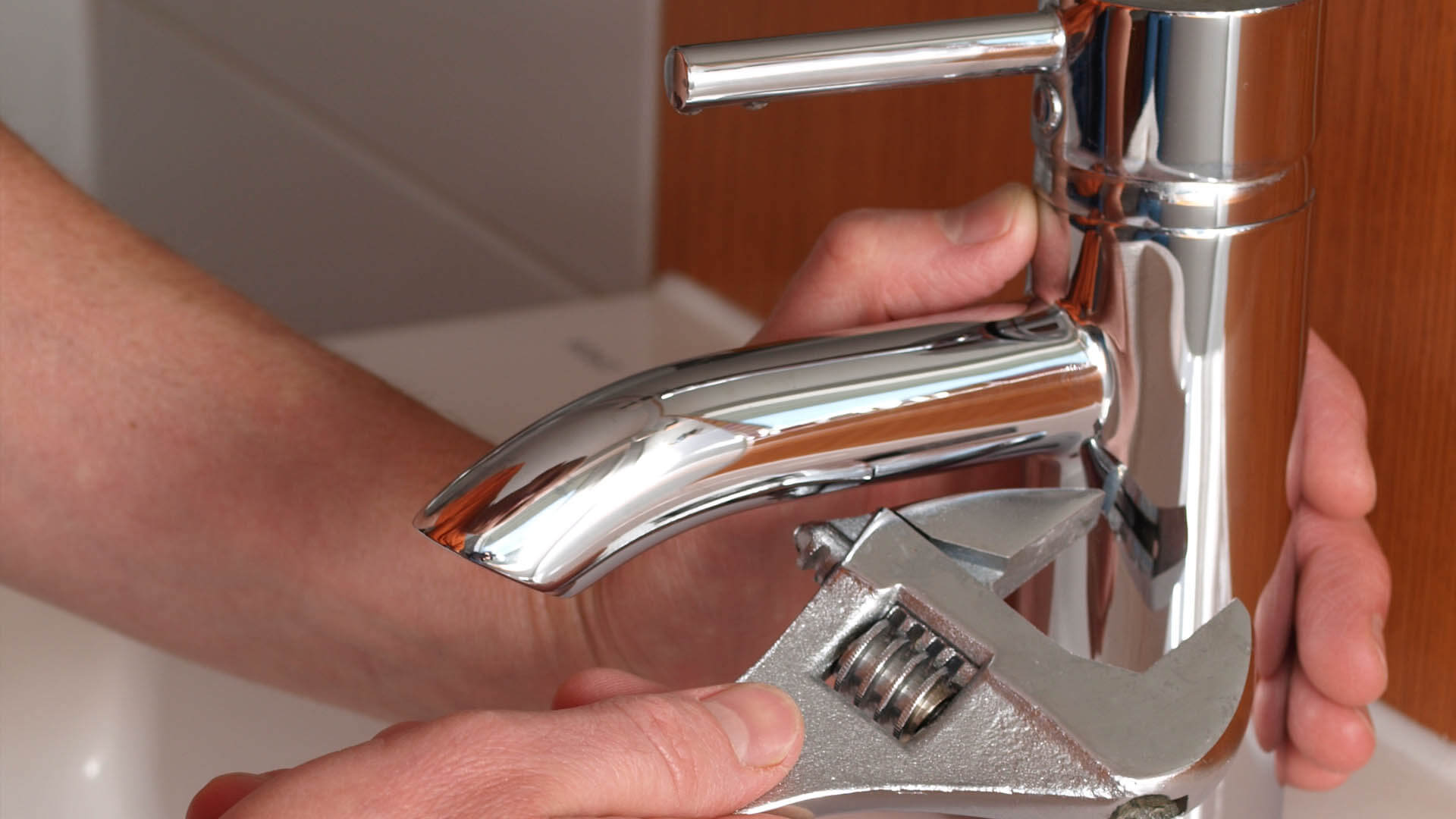 Bathroom faucet being replaced by Curtis Plumbing.